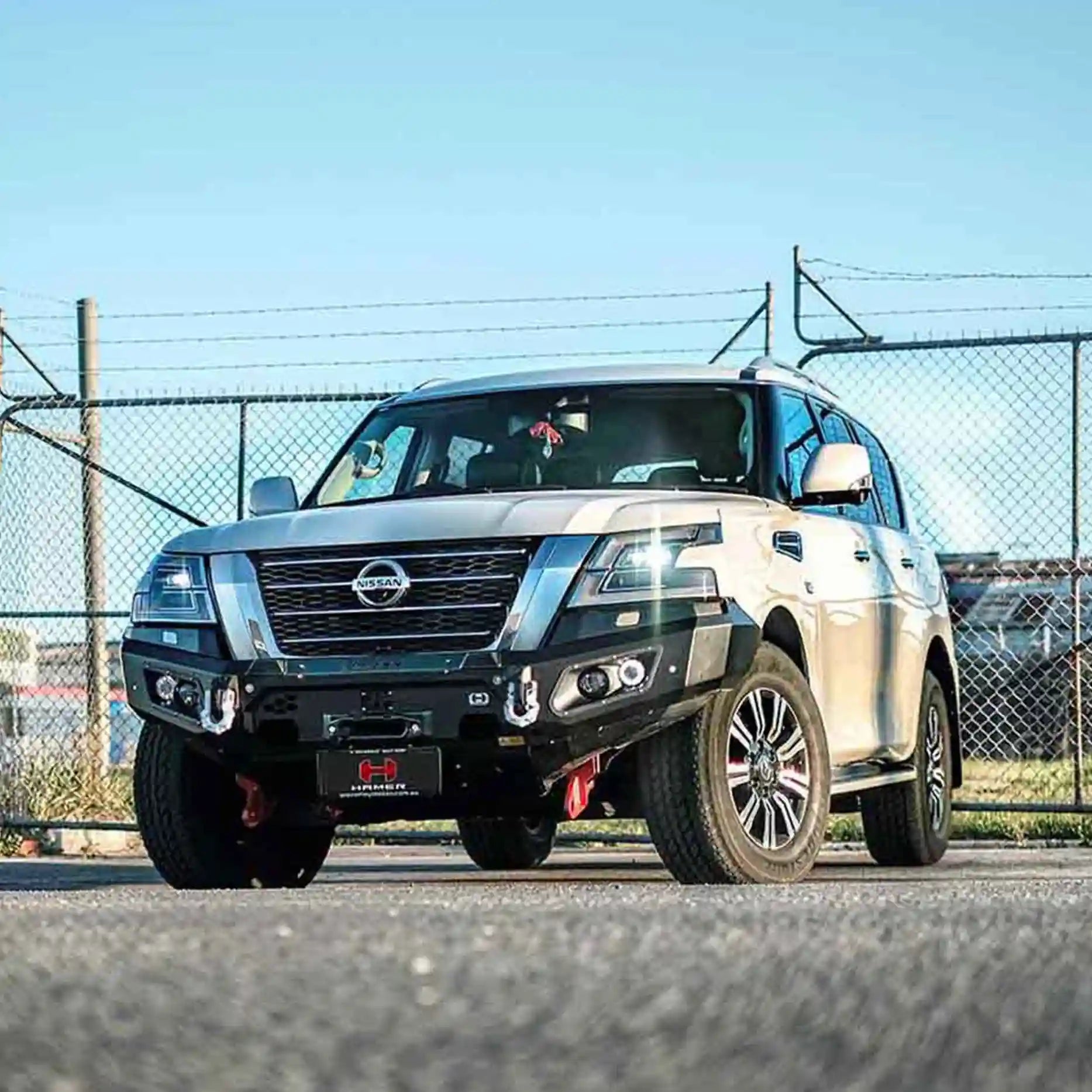 Right side angle of Nissan Patrol Y62 with Hamer King Bull Bar, featuring rated recovery points and stylish design.