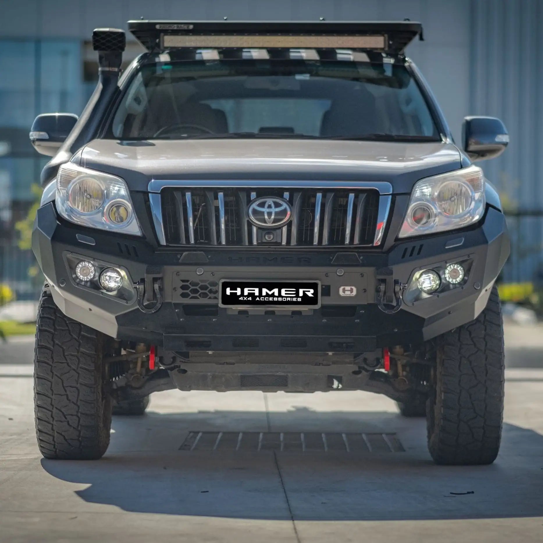 Closeup front of Prado 150 (2009–2013) showcasing Hamer King Bull Bar, E-Mark LED lights and sleek integrated finish.