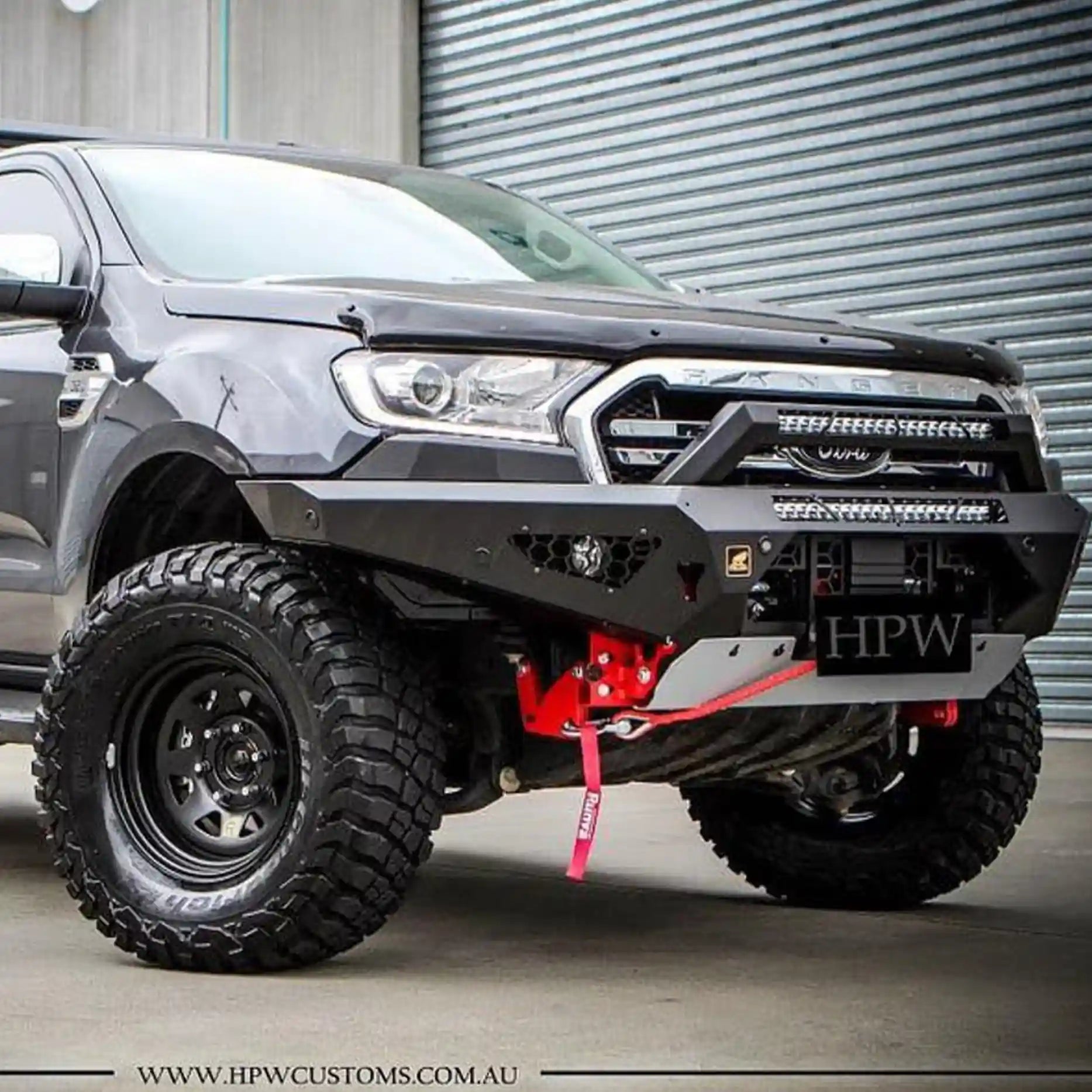 Left-angle installed view of the Offroad Animal Predator Bull Bar on a Ford Ranger PX3, showcasing its sleek integration with the body lines and high-clearance design. Supplied by Elevated 4x4 Australia, this matte black bull bar delivers top-tier performance, superior airflow, and modern styling perfect for serious 4WD touring and rugged conditions.