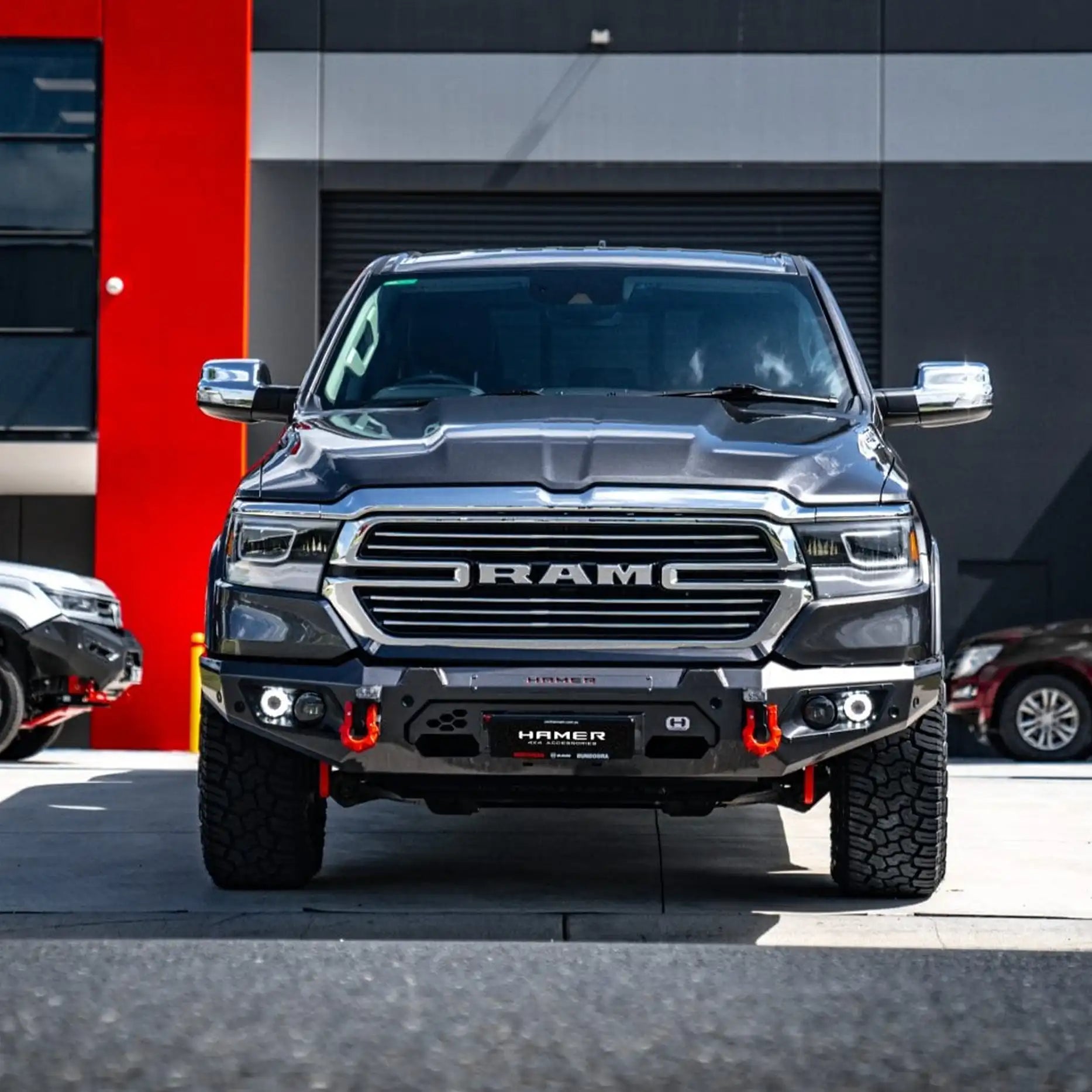 Front view of Ram 1500 DT (2021–Present) fitted with Hamer King Bull Bar, 3mm steel build, matte black finish and integrated LED lights.