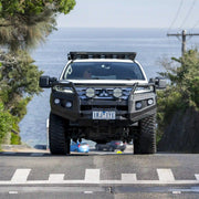 front view of mitsubishi pajero sport fitted with raxar loop type bull bar featuring adr compliance bumper replacement design recovery points and durable matte black finish engineered for maximum offroad protection and style available across australia from elevated 4x4