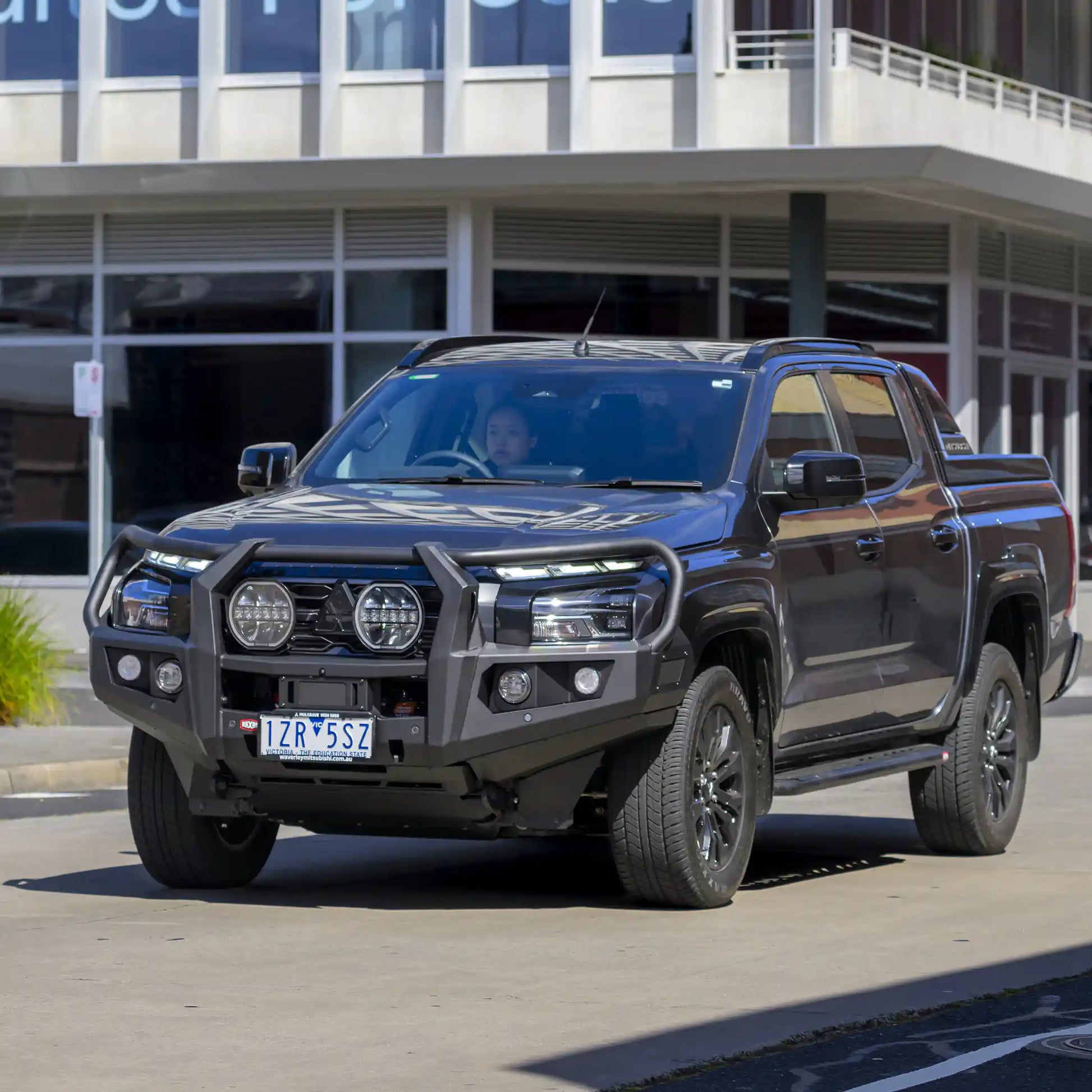 right installed view of raxar looped bull bar on mitsubishi triton mv showcasing underbody bash plates split pan airflow design high lift jacking points and sensor compatibility built tough for offroad adventures and urban use supplied by elevated 4x4