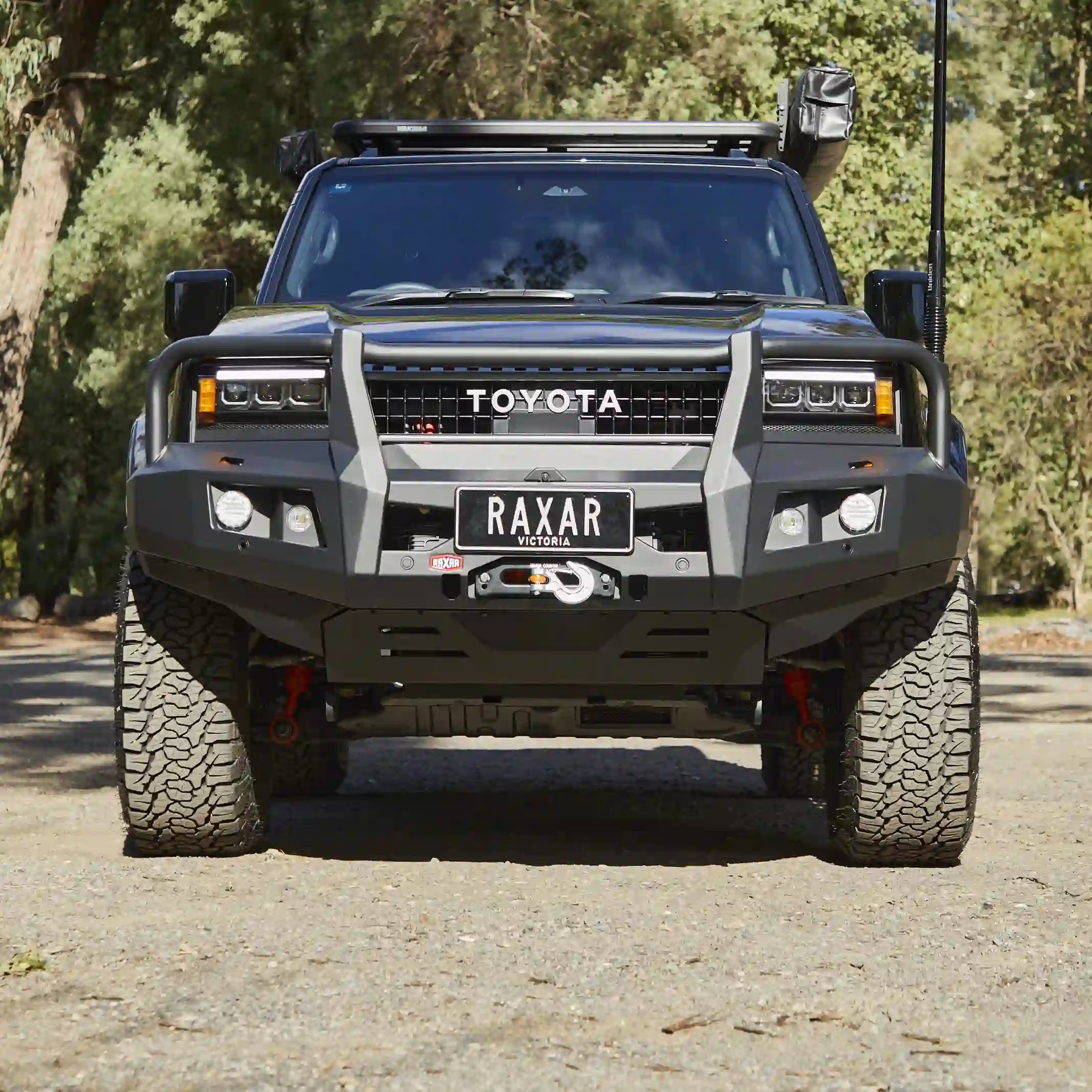 The Toyota Prado 250 looped bull bar front-installed view from Elevated 4x4 showcases premium RAXAR engineering with a durable matte black finish, ADR compliance, and full winch compatibility. Built tough for Australian 4WD conditions, this bull bar delivers unmatched front-end protection and a bold off-road style trusted by serious adventurers.
