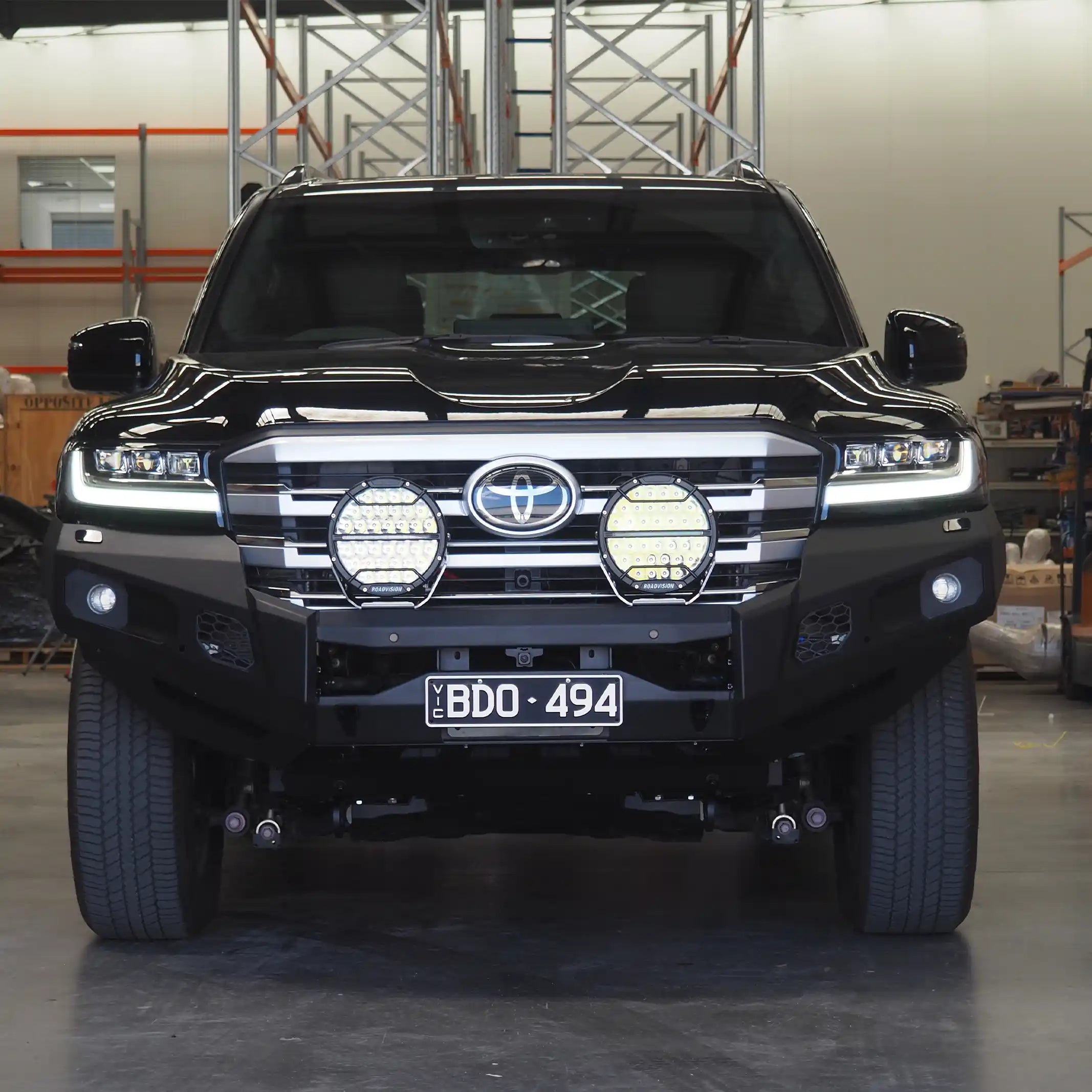 The Toyota LandCruiser 300 front-installed no loop bull bar from Elevated 4x4 showcases RAXAR’s tough bumper replacement design, matte black powder-coated finish, and ADR compliance. Built for Australian 4WD drivers, it delivers reliable protection, winch compatibility, and a bold front-end style for both touring and off-road conditions.