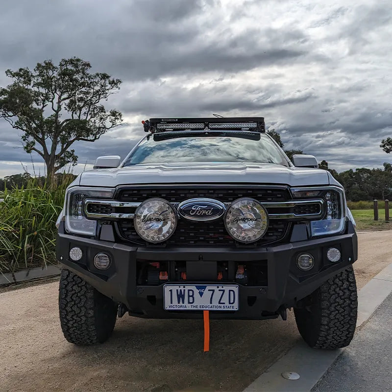 The RAXAR no loop bull bar (Part No: ST37FR22V1) fitted on a Ford Next-Gen Ranger, showcasing its modern bumper replacement design, durable matte black finish, and seamless integration with factory sensors. ADR-compliant and fully winch compatible, this bull bar delivers protection and style, available at Opposite Lock Cardiff for drivers across Newcastle, Maitland, Hunter Valley, Rutherford, Central Coast, Port Stephens, and Nelson Bay.
