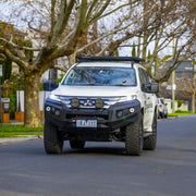 front installed view of mitsubishi pajero sport fitted with raxar no loop bull bar featuring adr compliance full winch compatibility recovery points and durable matte black finish engineered for australian offroad protection available from elevated 4x4