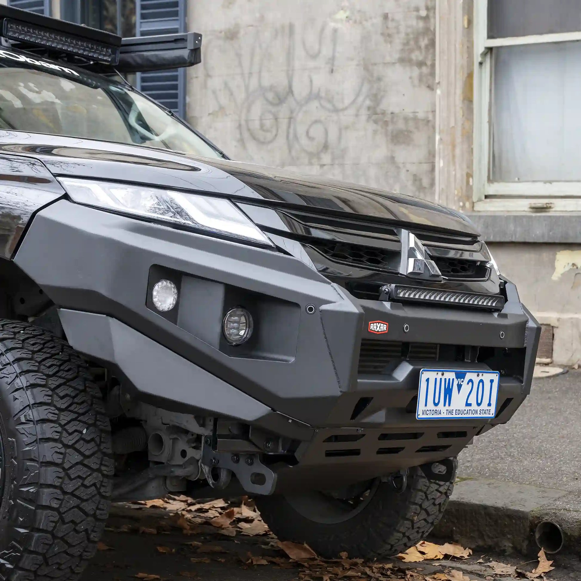 raxar no loop bull bar fitted to mitsubishi triton mr front installed view featuring adr compliant bumper replacement design split pan airflow underbody bash plates 4 tonne rated recovery points fog light compatibility full winch readiness and durable e coated powder coated matte black finish engineered for australian worksites city driving and offroad touring available across australia from elevated 4x4