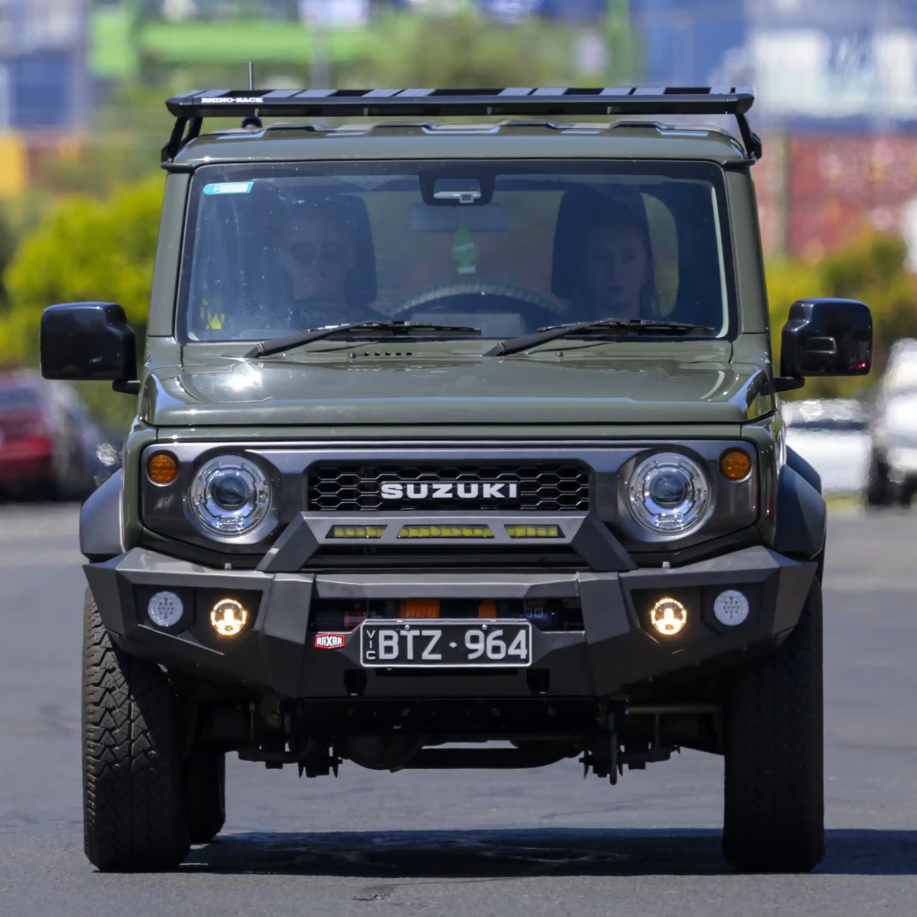 front installed view of raxar no loop bull bar fitted to suzuki jimny showing adr compliant bumper replacement design matte black powder coat finish and full winch compatibility tough 4wd protection engineered by elevated 4x4