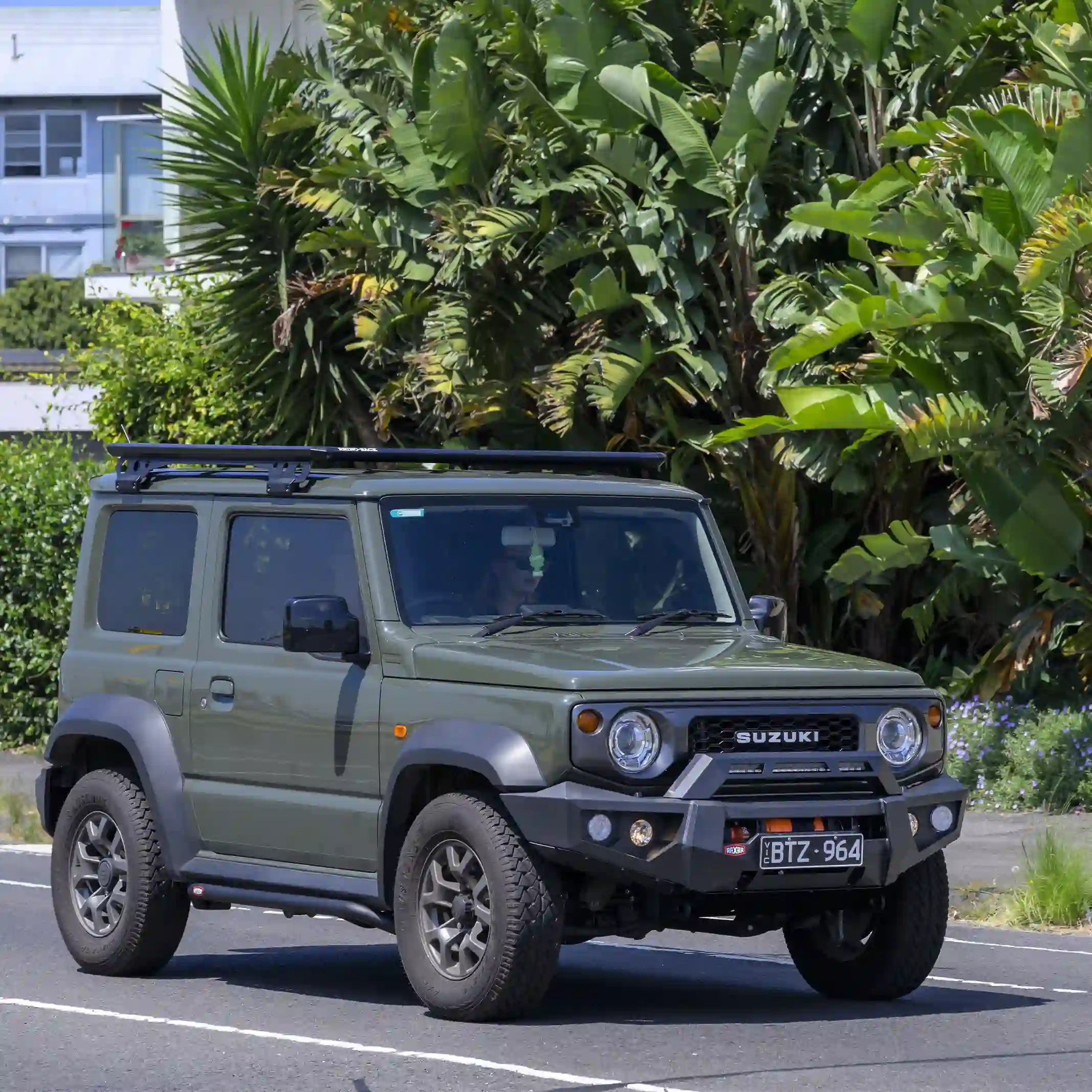 left installed view of suzuki jimny with raxar no loop bull bar highlighting underbody bash plates 4 tonne rated recovery points high lift jacking points and airflow enhancing split pan design built strong by elevated 4x4