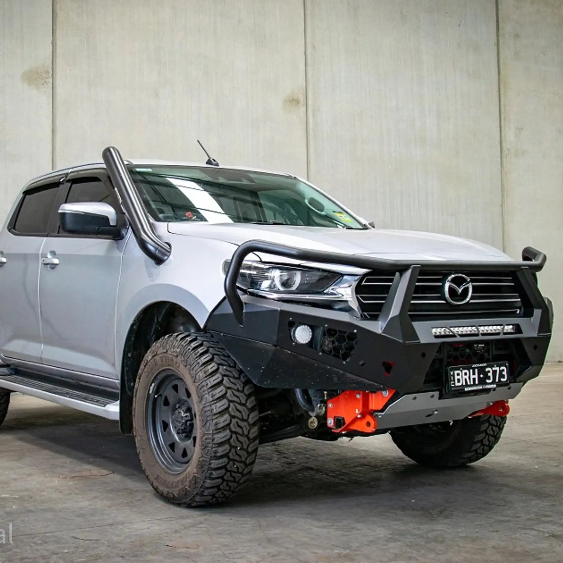 Left-side angle of the Offroad Animal Toro Bull Bar fitted to a Mazda BT-50 2024 model, capturing its aggressive contour and smart integration with sensors and fog lights. Elevated 4x4 designs problem-solving 4WD accessories for superior style, safety, and off-road readiness.