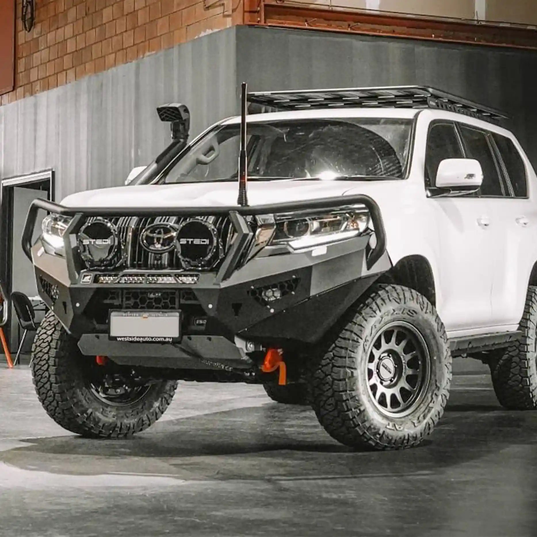 Left side view of the Offroad Animal Toro Bull Bar on a Toyota Prado 150 Series, showcasing precise body alignment, dual cube light mounting options, and zinc-plated finish. Fitted by Elevated 4x4, it offers superior clearance, airflow, and bold styling for 4WD adventures throughout Newcastle and surrounding areas.