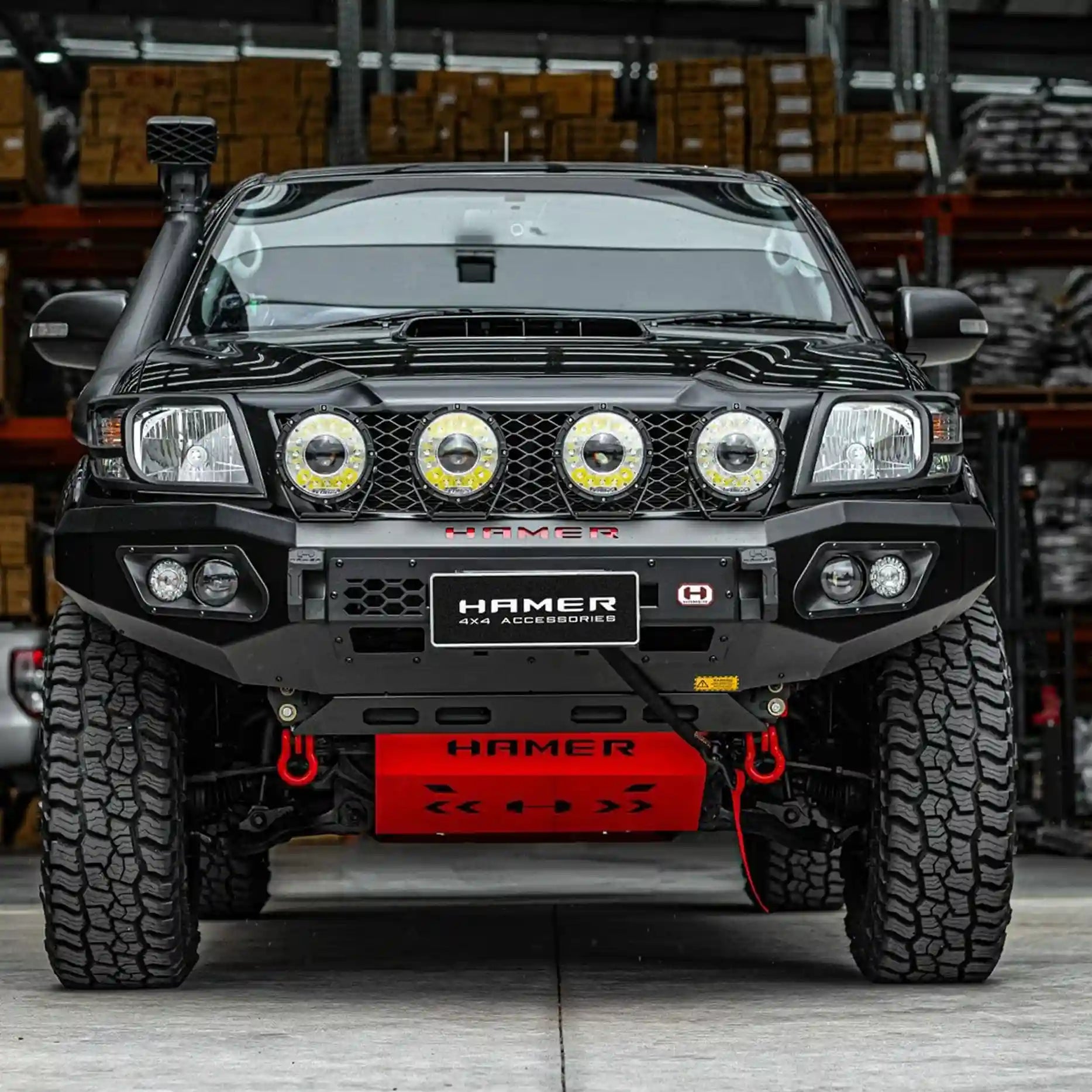Front view of Toyota Hilux 2011–2015 with Hamer King Bull Bar, ADR compliant, matte black steel with LED fog and DRL lights.