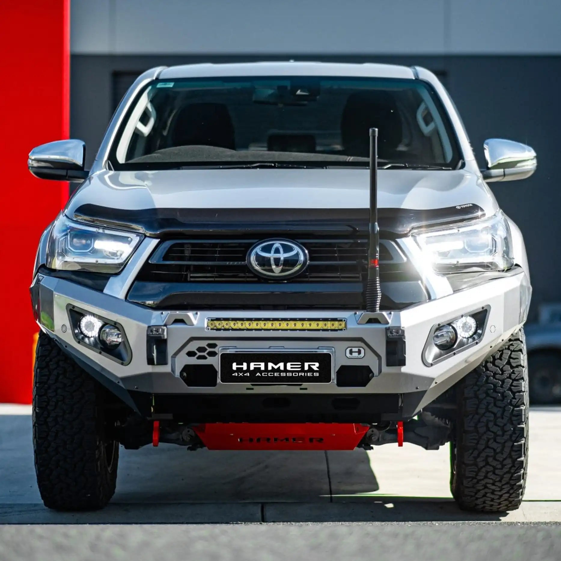 Front view of 2024 Hilux with Hamer King Bull Bar, 3mm steel, ADR compliant, winch ready, matte black finish with LED lights.