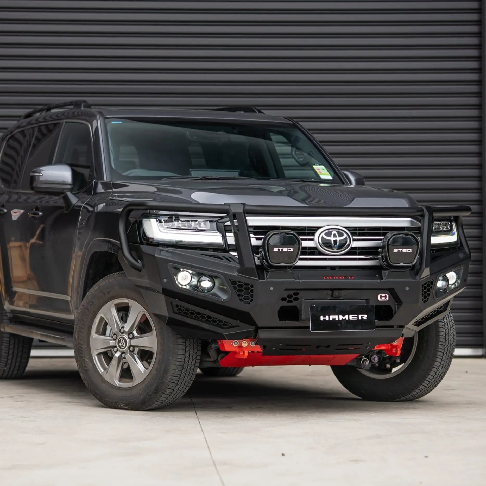 Left side Landcruiser 300 with Hamer King Series Plus Bull Bar, triple loop design, factory sensor compatible, rugged and stylish finish.