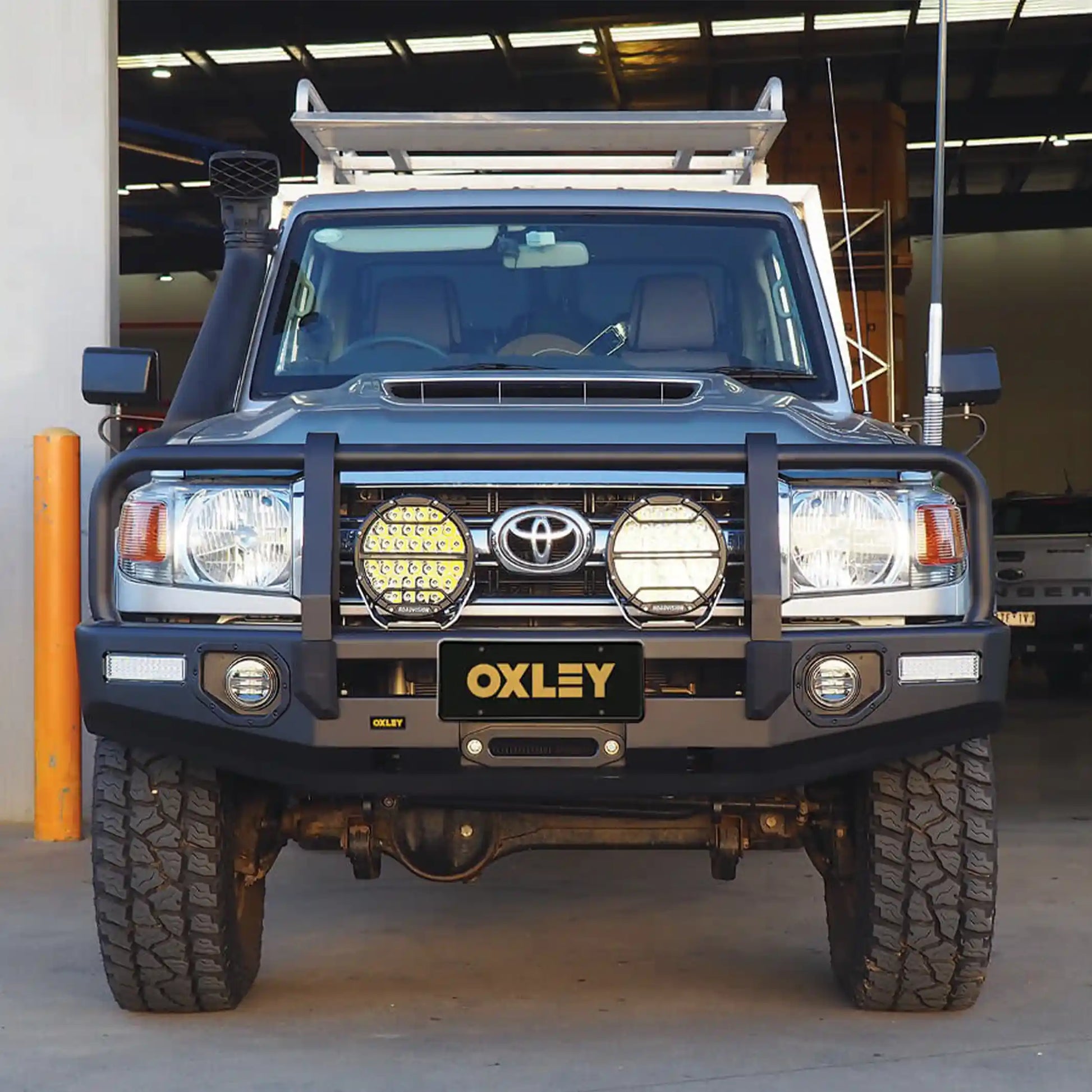 front installed oxley bull bar on toyota landcruiser 70 single cab showing adr compliant matte black design elevated 4x4