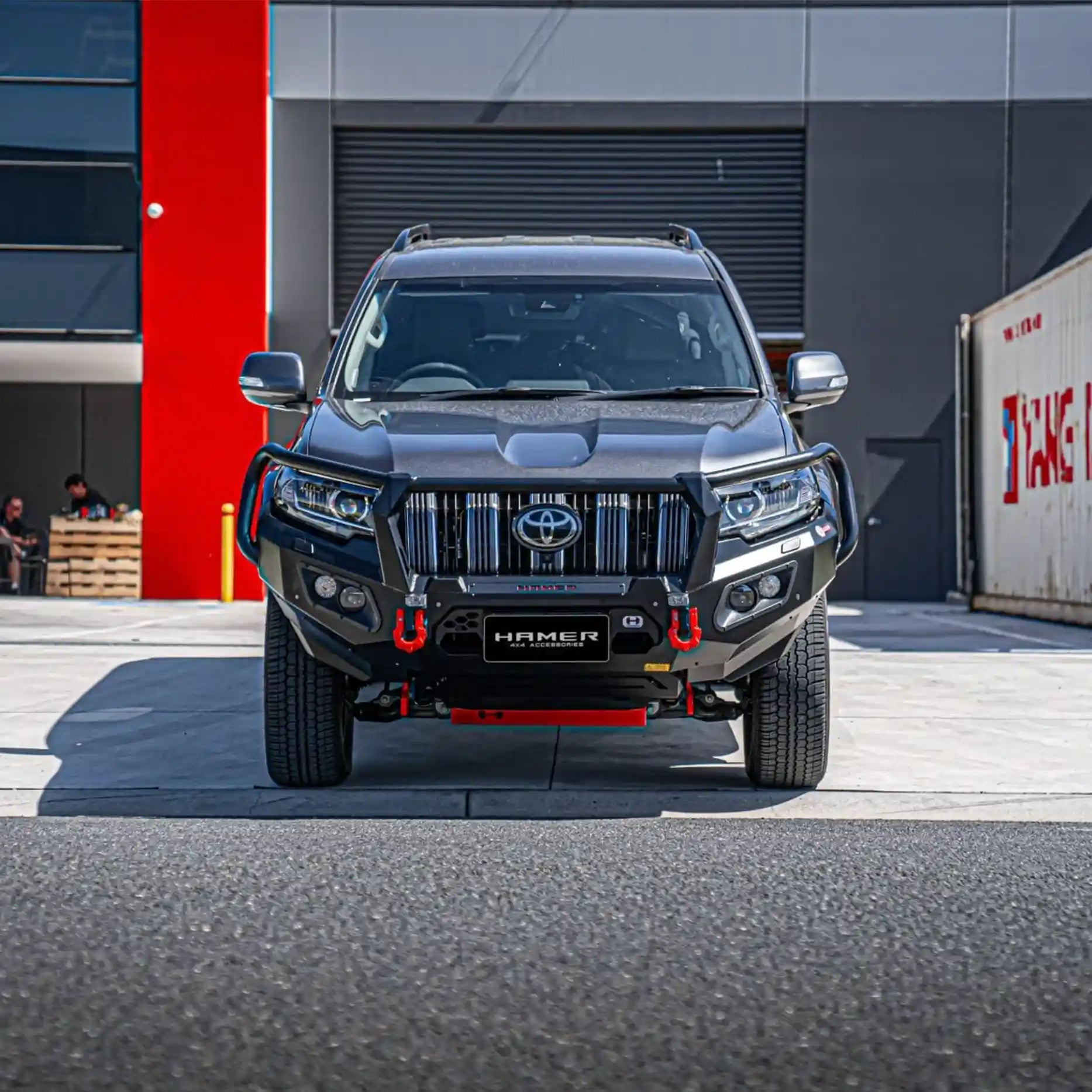Front view of Toyota Prado 150 fitted with Hamer King Plus Bull Bar, showing matte black finish, integrated LED lights, and ADR safety compliance.