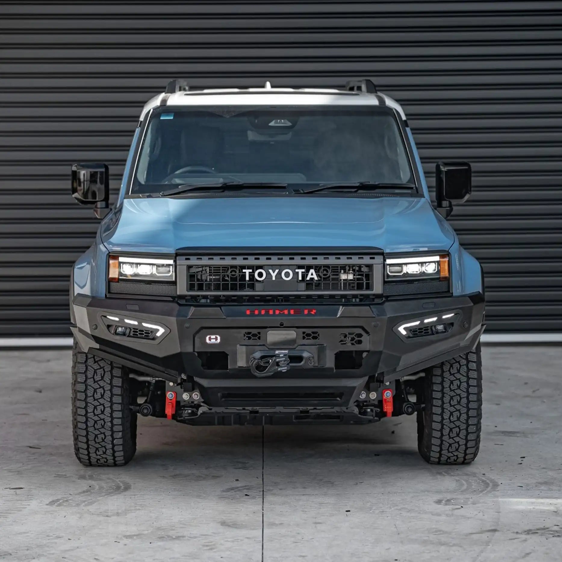 Front view of Hamer Atlas Series Bull Bar on Toyota Landcruiser Prado 250 Series 2024 – Present, showing full bumper replacement, ADR / Airbag compliance, and E-Mark certified LED daytime running lights.