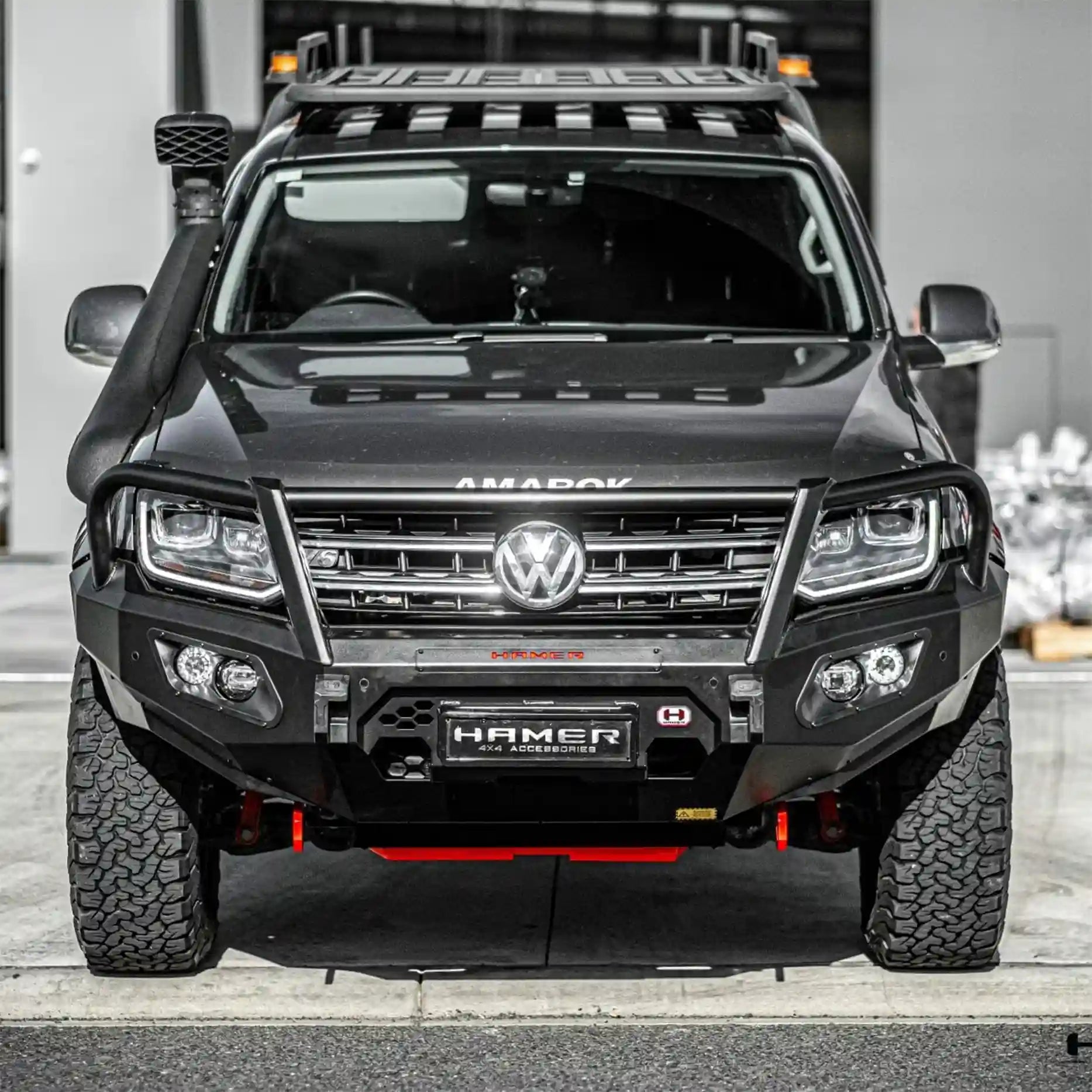 Front view of Volkswagen Amarok (2010–2022) fitted with Hamer King Series Plus Bull Bar, matte black finish, ADR compliant, with LED fog lamps and winch compatibility.